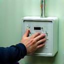 Technician installing a smart meter device with modern equipment